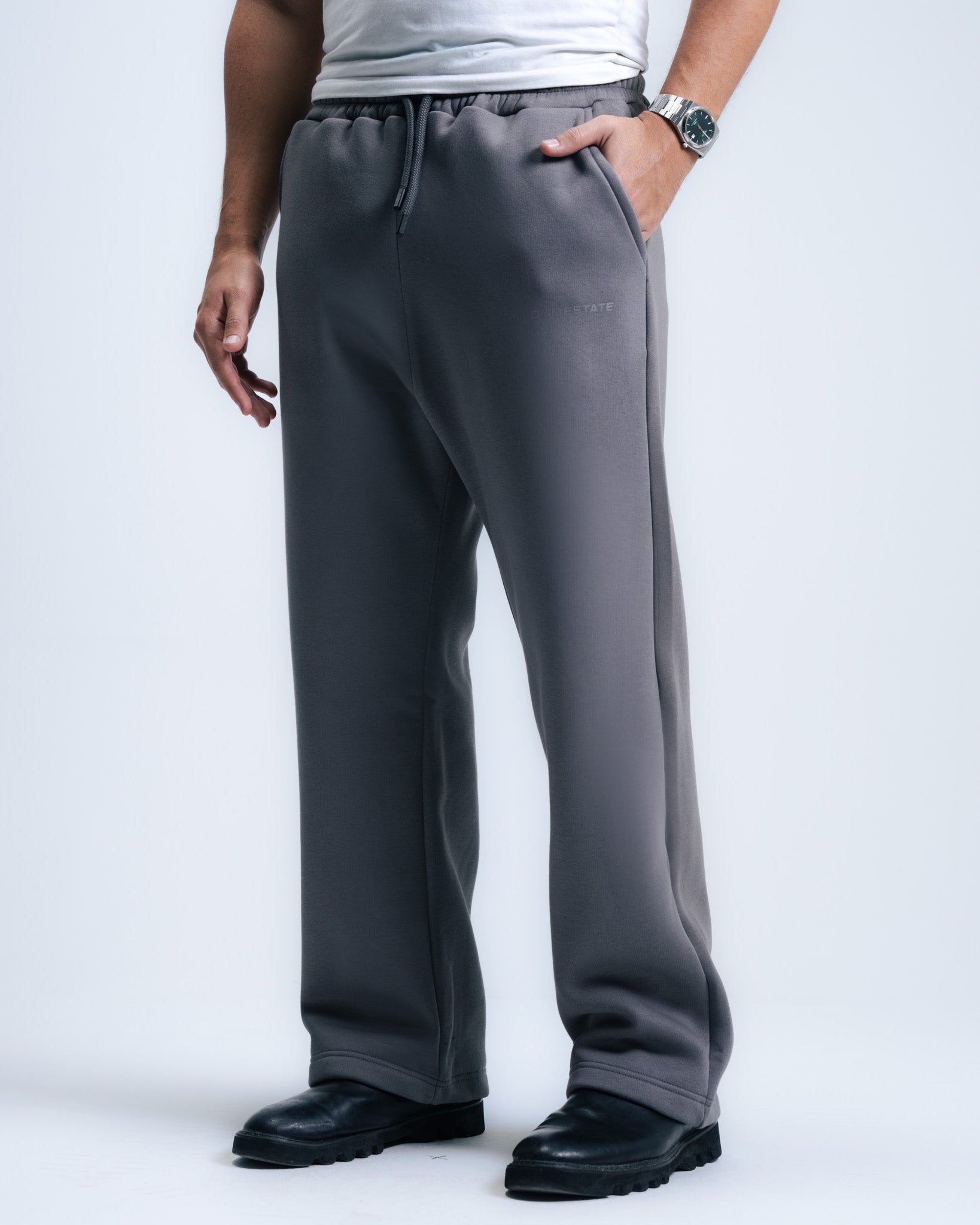 Person wearing gray sweatpants on a white background