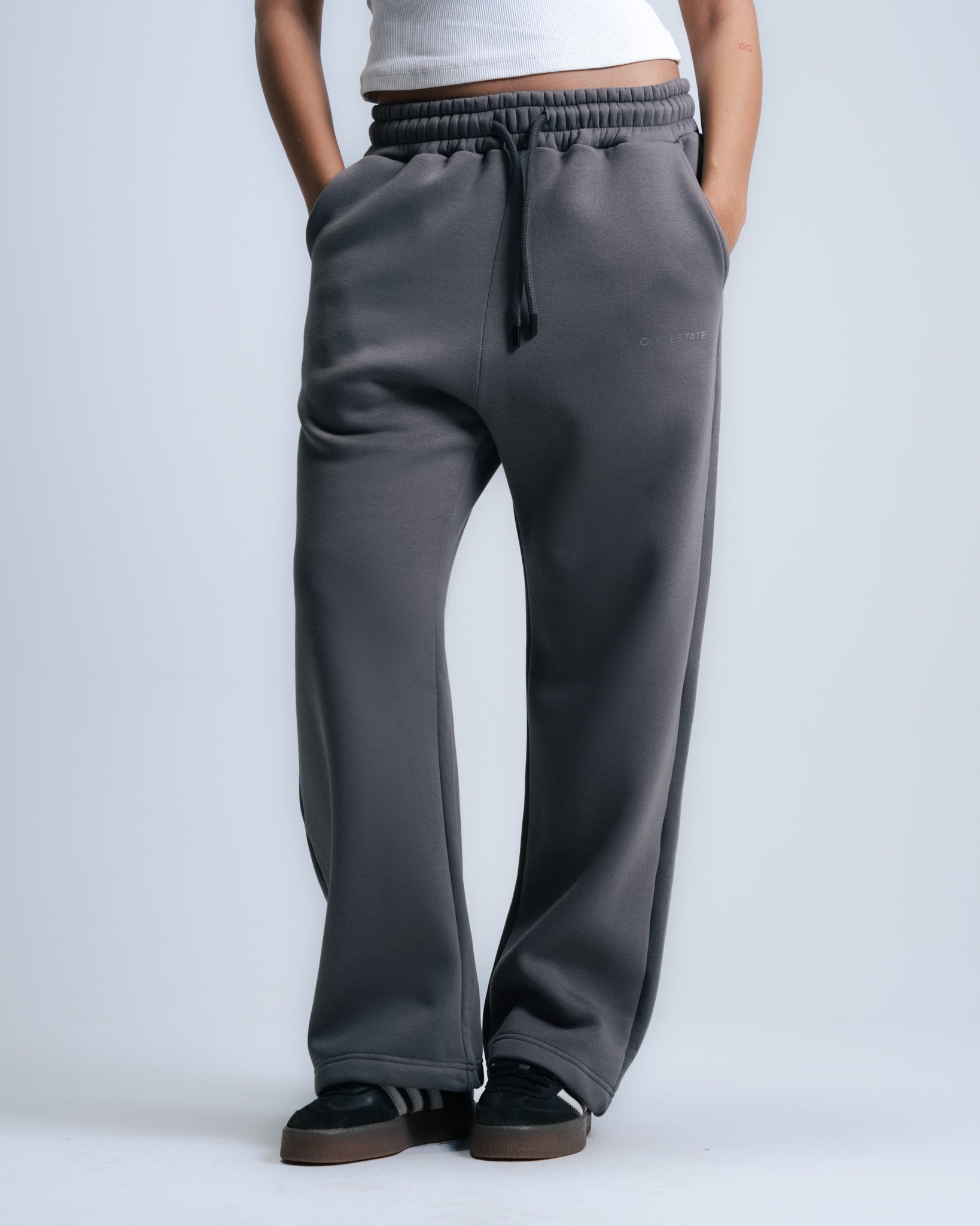 Person wearing gray sweatpants on a white background