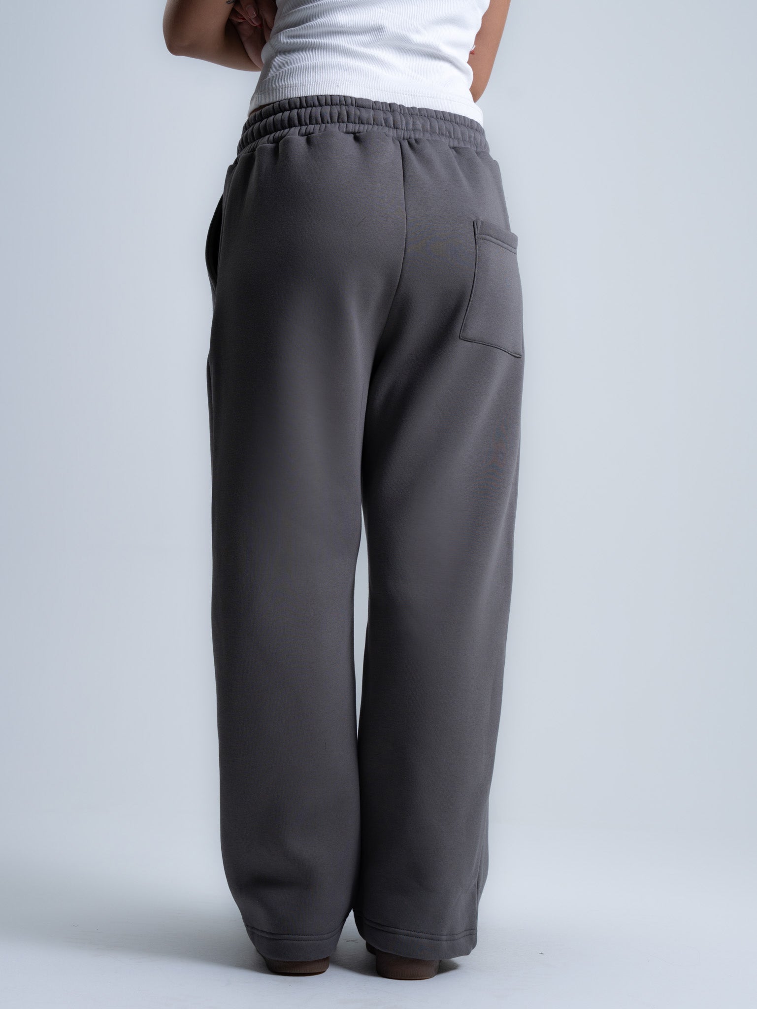 Gray pants worn by a person on a light gray background