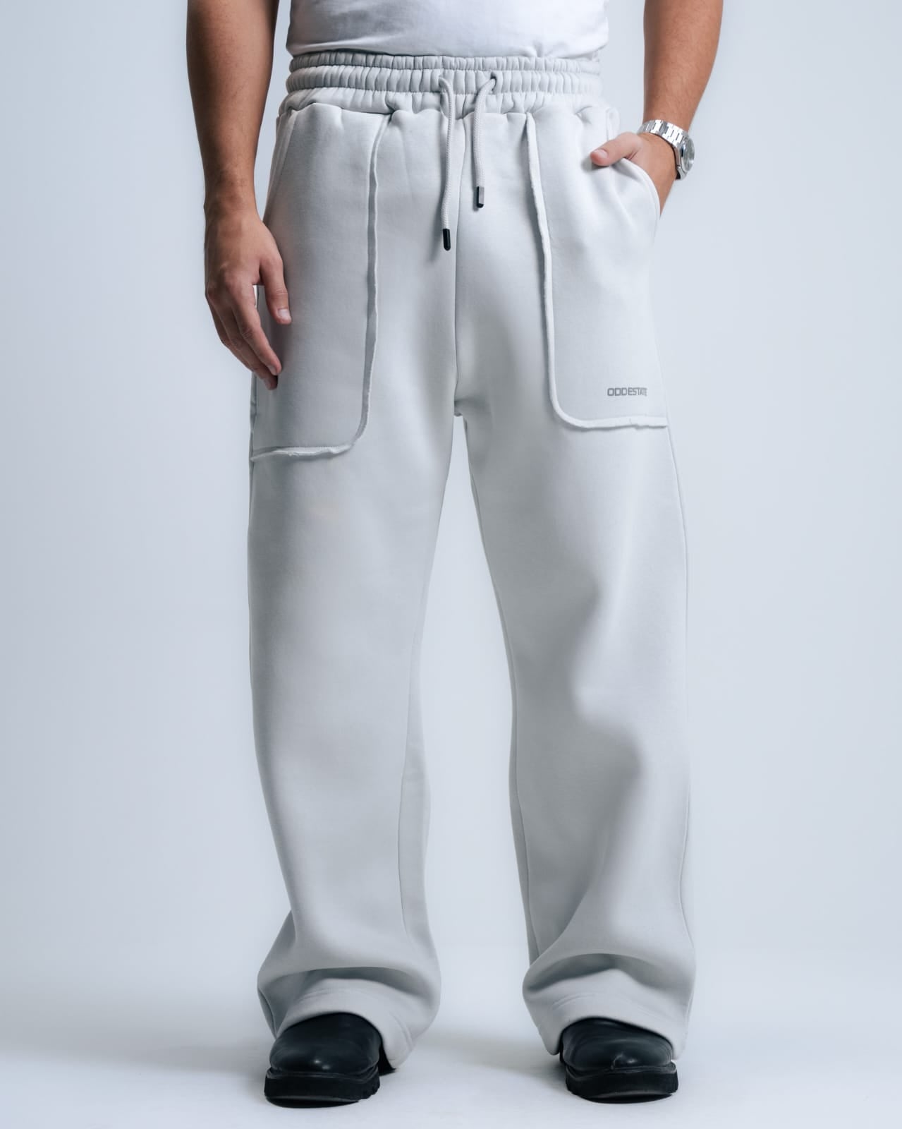 Person wearing gray sweatpants on a white background