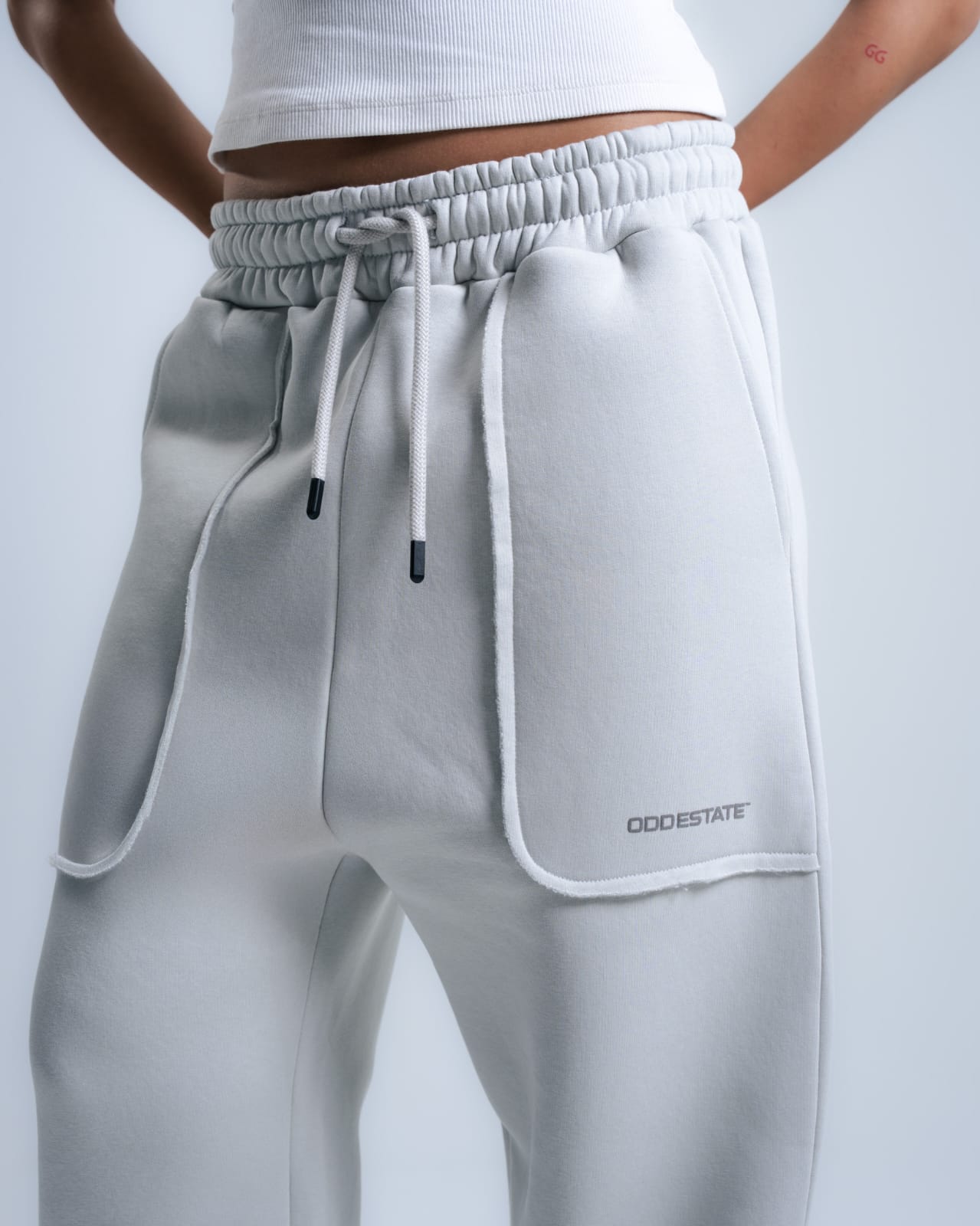 Gray sweatpants with a brand logo on a light gray background